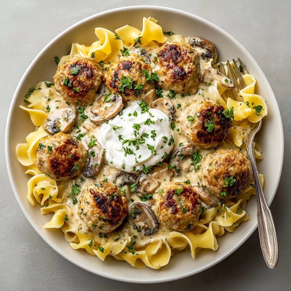 Double batch of slow cooker turkey meatball stroganoff, steam rising from the rich mushroom gravy
