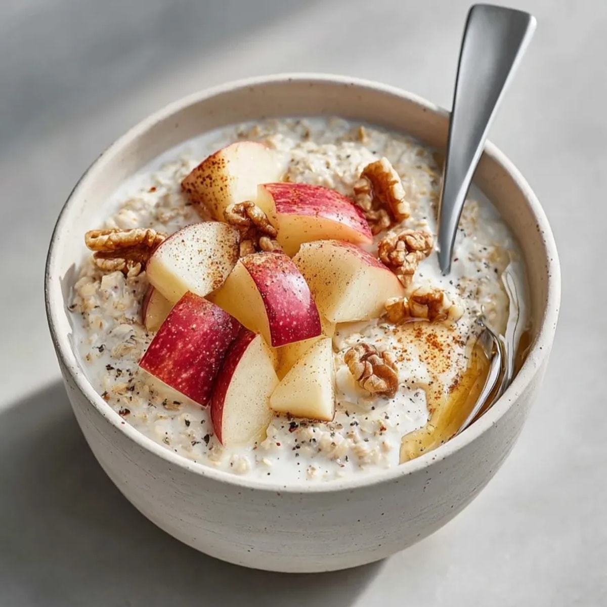 Easy Cinnamon Apple Overnight Oats recipe, layered in a mason jar, ready to grab &amp; go.