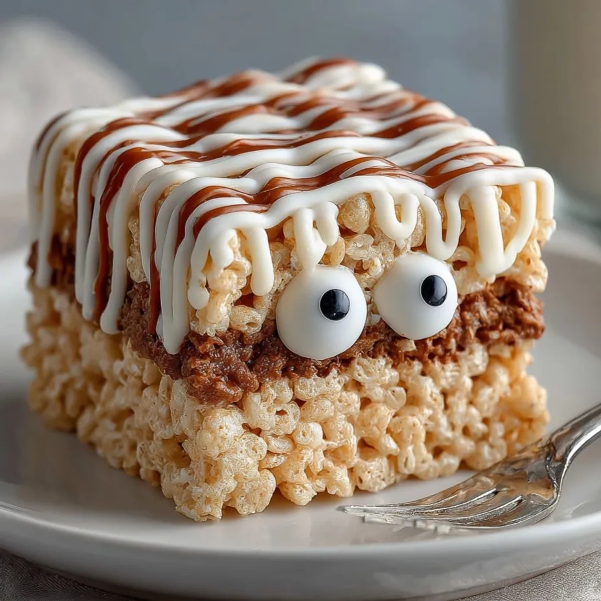 Homemade Mummy Rice Krispie Treats recipe ready for Halloween parties, stacked on a plate.