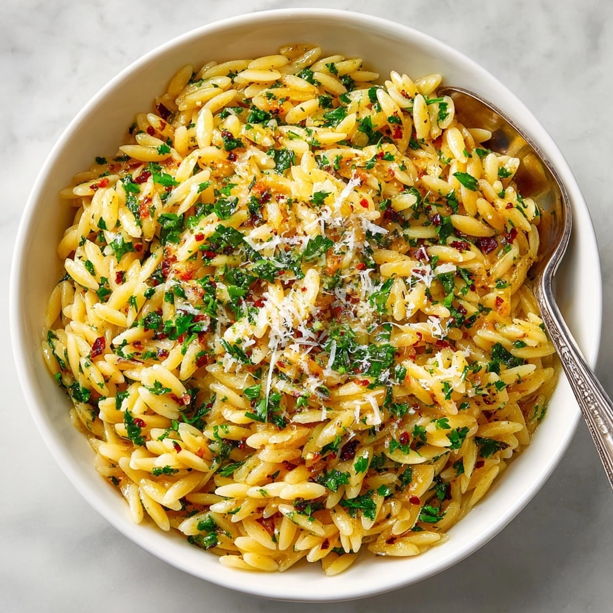 Enjoy warm, comforting Herb-Roasted Garlic Orzo, speckled with herbs and roasted until golden.