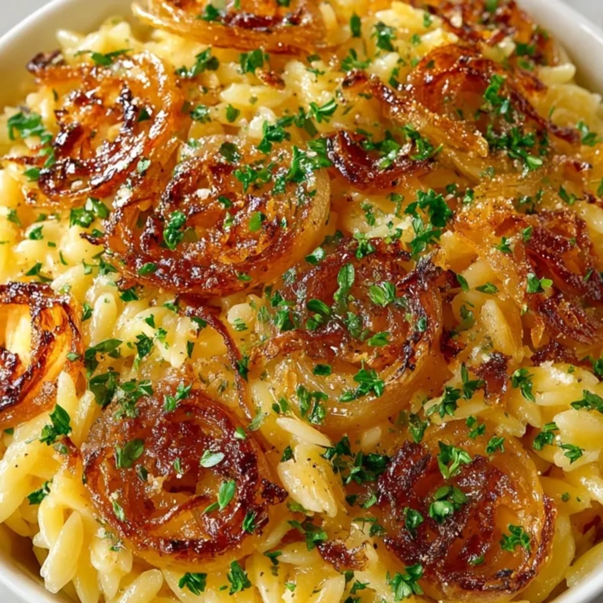 Close-up of creamy Caramelized Onion Orzo, glistening with Parmesan, ready to serve.