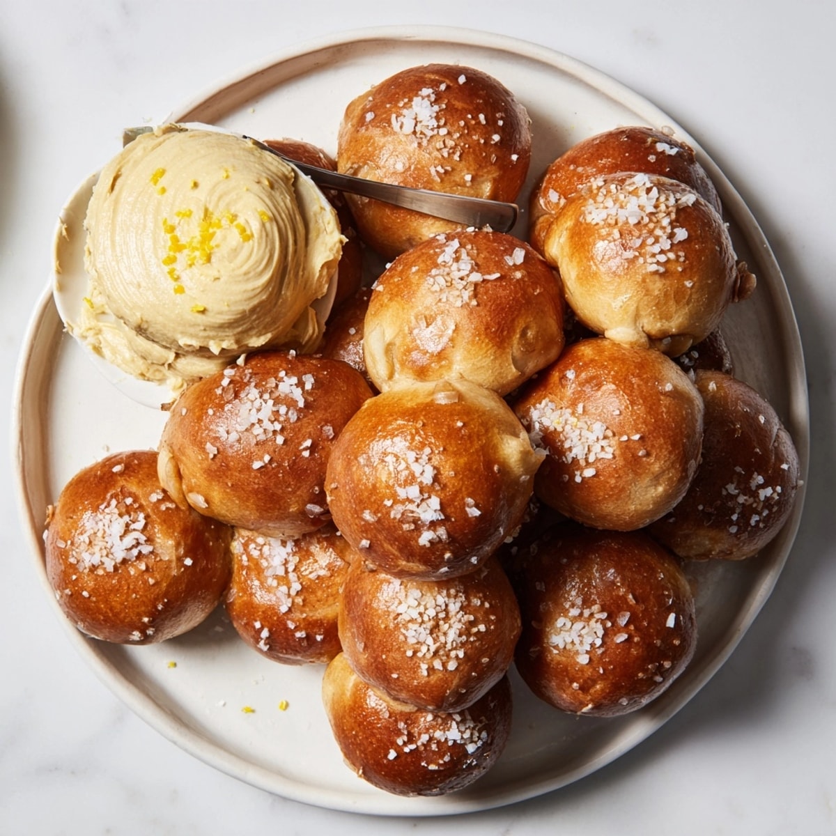 Warm, chewy Holiday Snack Pretzel Bites dunked in creamy miso butter, a perfect appetizer.