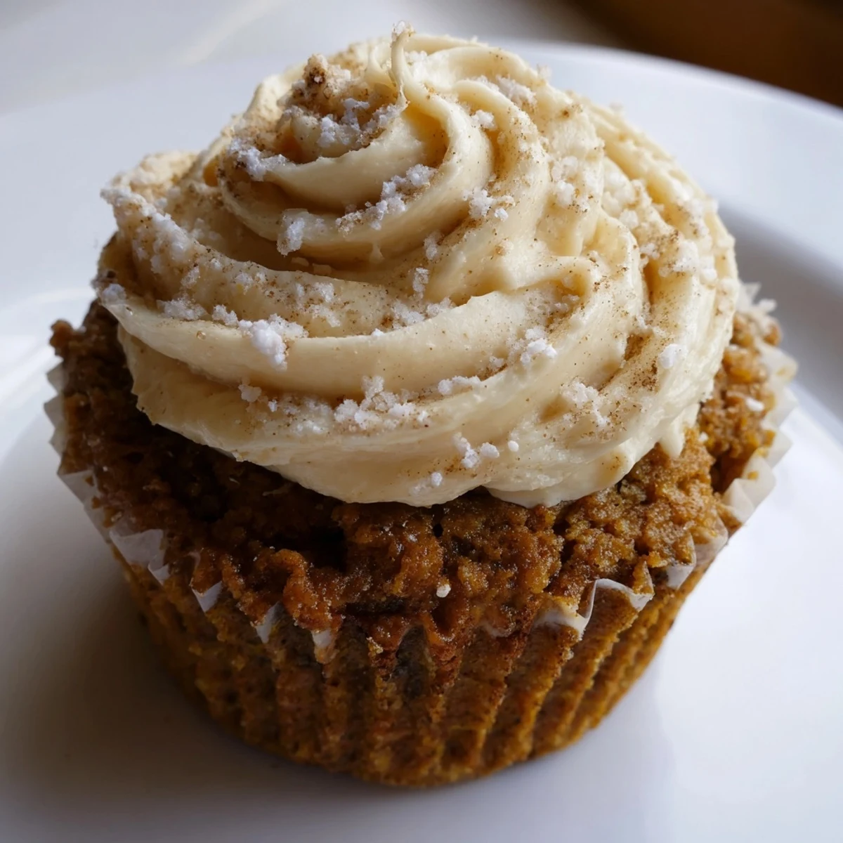 Moist root beer pumpkin cupcakes topped with creamy frosting, perfect for fall celebrations.  