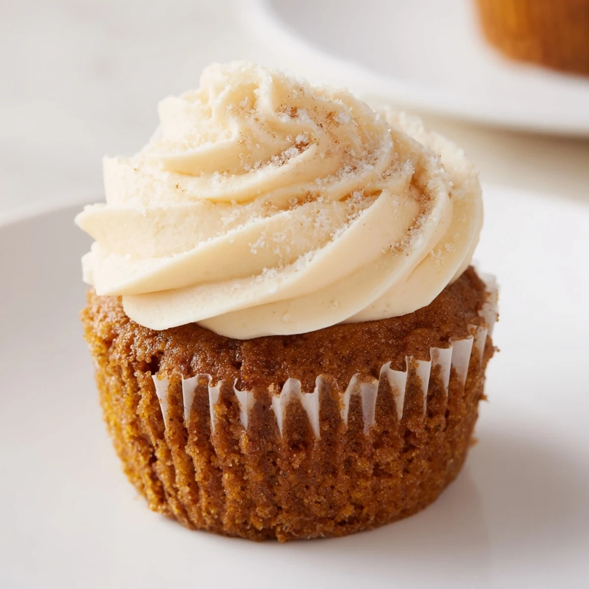 Fluffy cream cheese frosting on root beer pumpkin cupcakes, an irresistible treat for any occasion.