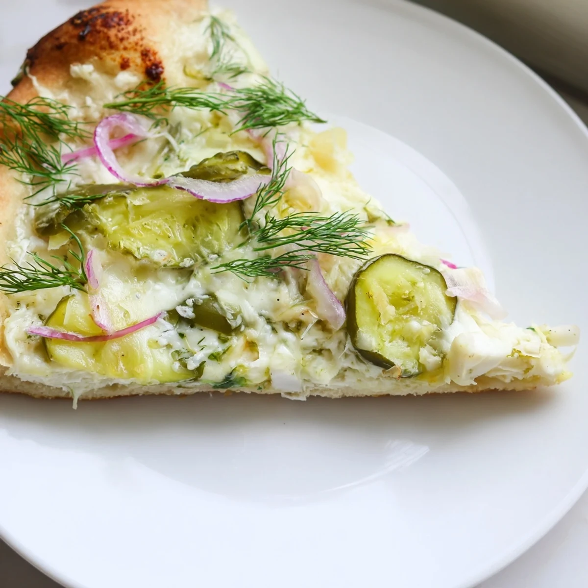 Tangy Pickle Pizza with creamy sauce and melted mozzarella, perfect for adventurous eaters.  