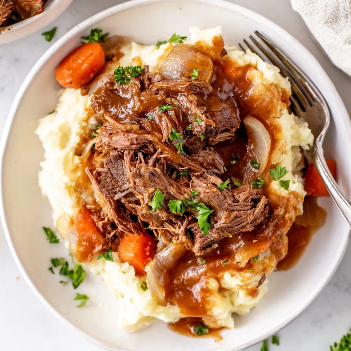 Slow Cooker Pot Roast with Mashed Potatoes served with savory vegetables and rich gravy.