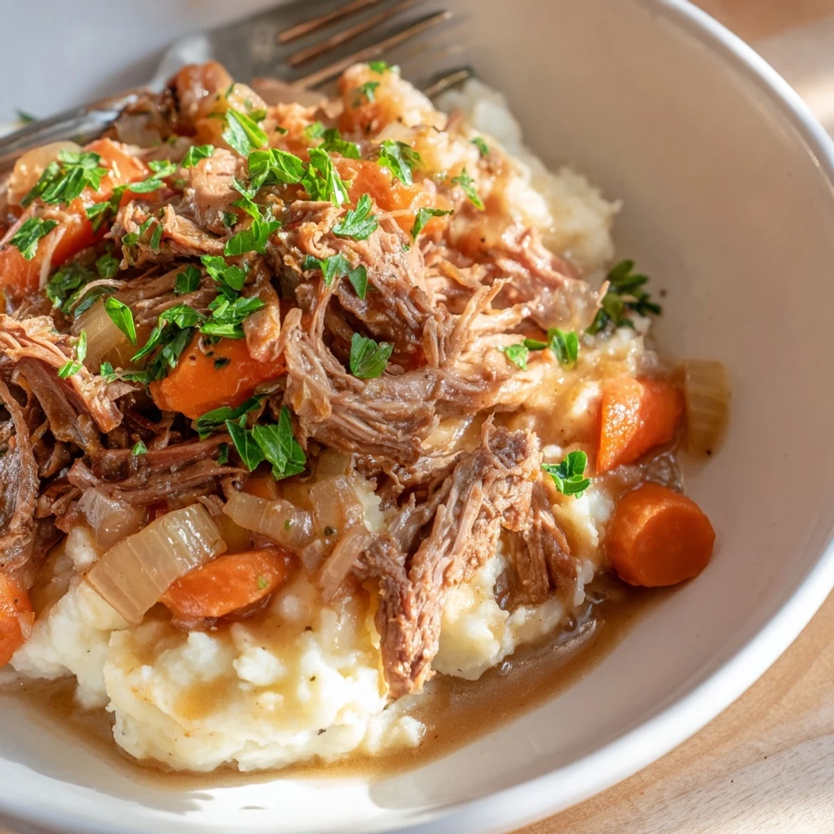Tender Slow Cooker Pot Roast with Mashed Potatoes garnished with fresh parsley and comfort.