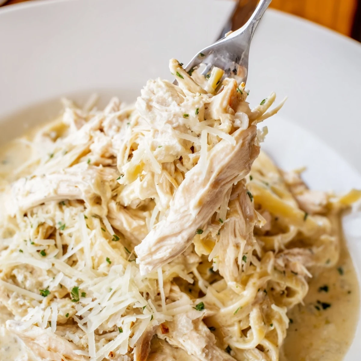 A close-up shot of creamy chicken Alfredo, a comforting slow-cooker dump meal.