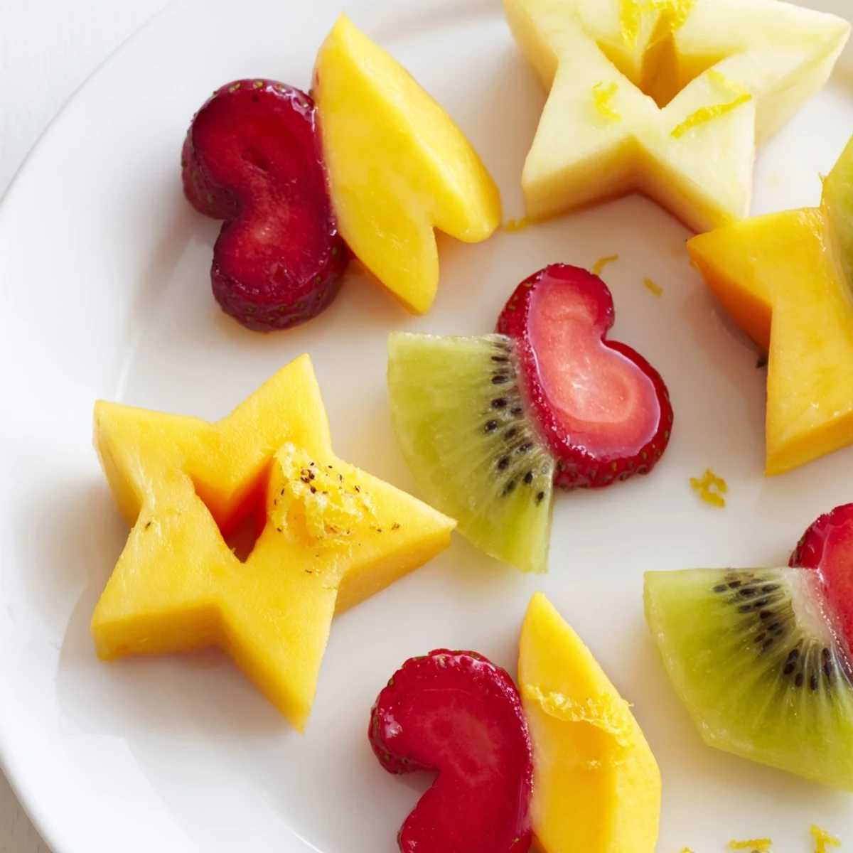 Midnight Kiss Star & Heart Cocktail Garnishes: Festive fruit shapes sparkle, ready to enhance midnight cocktails.