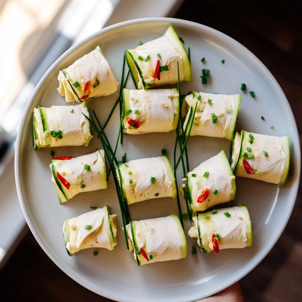 Stacked turkey roll-ups, vibrant with red peppers and cool cucumber, ready for a healthy appetizer.