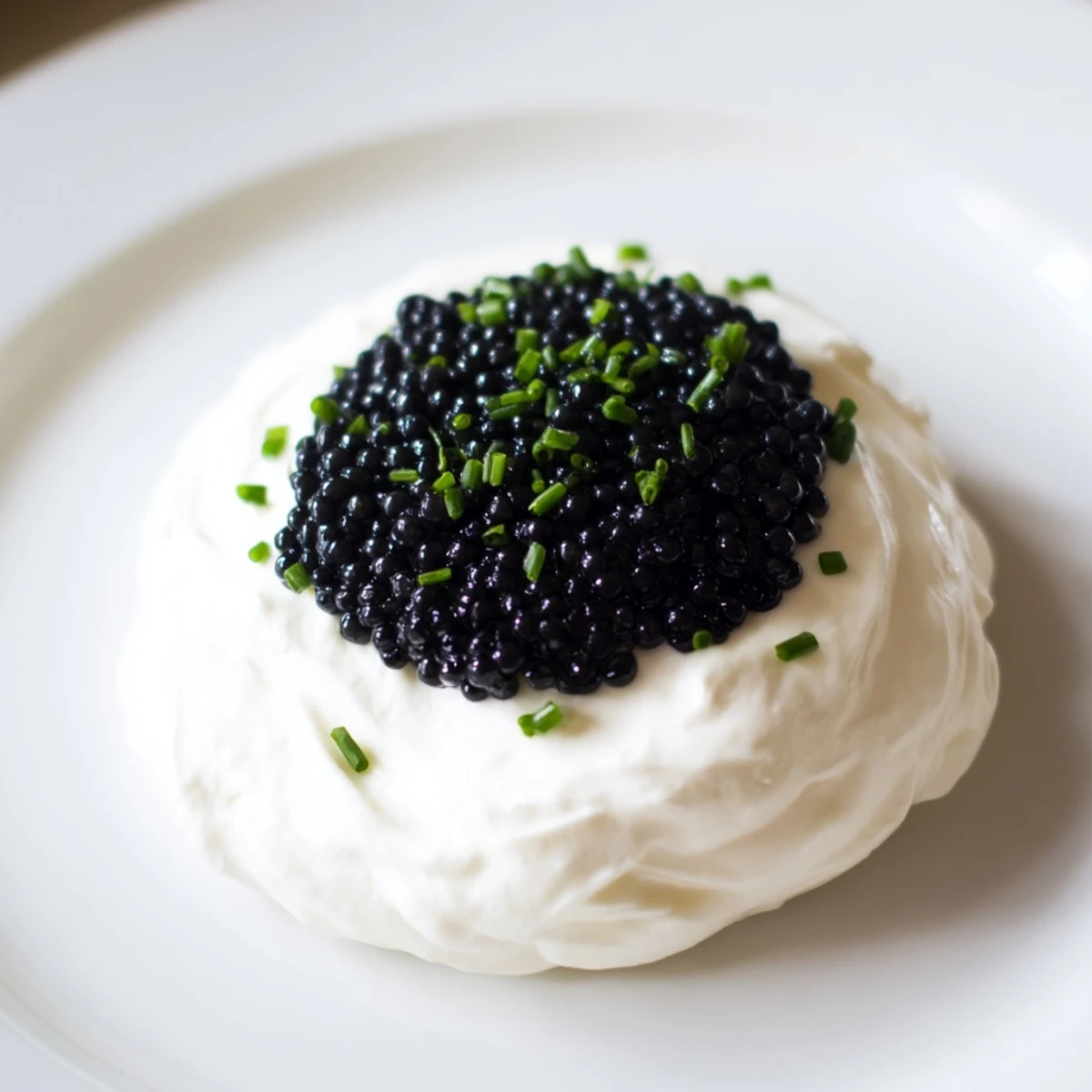 Elegant, creamy Diamond Inlay appetizer, featuring black caviar arranged in a decadent diamond shape.