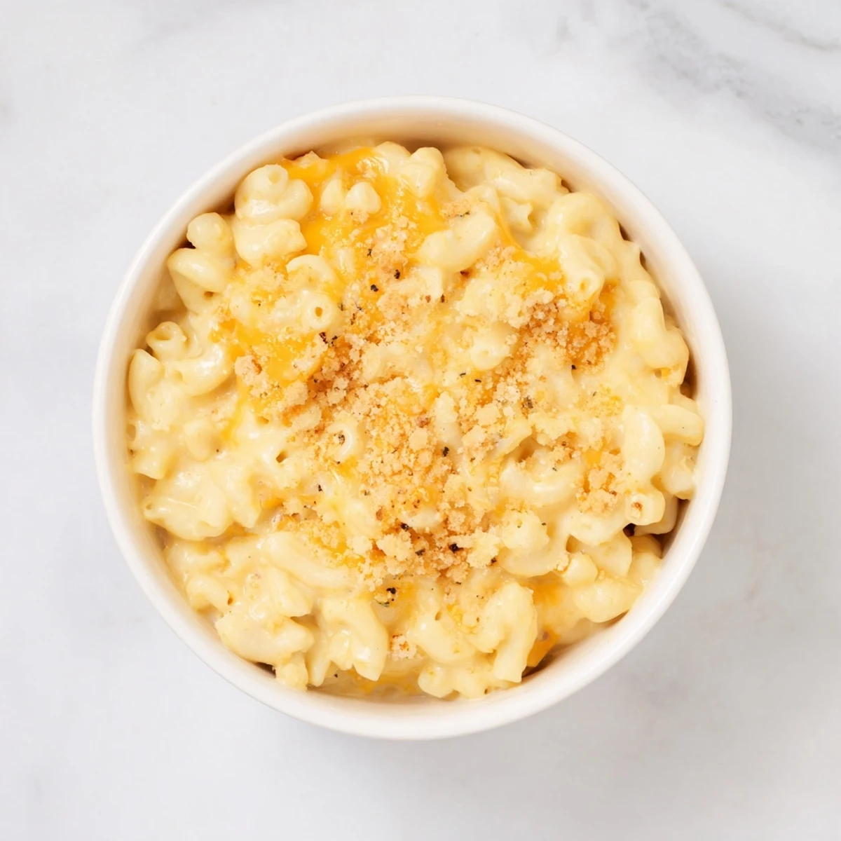 A generous helping of Tinis Recession Mac, creamy and cheesy, ready to be enjoyed.