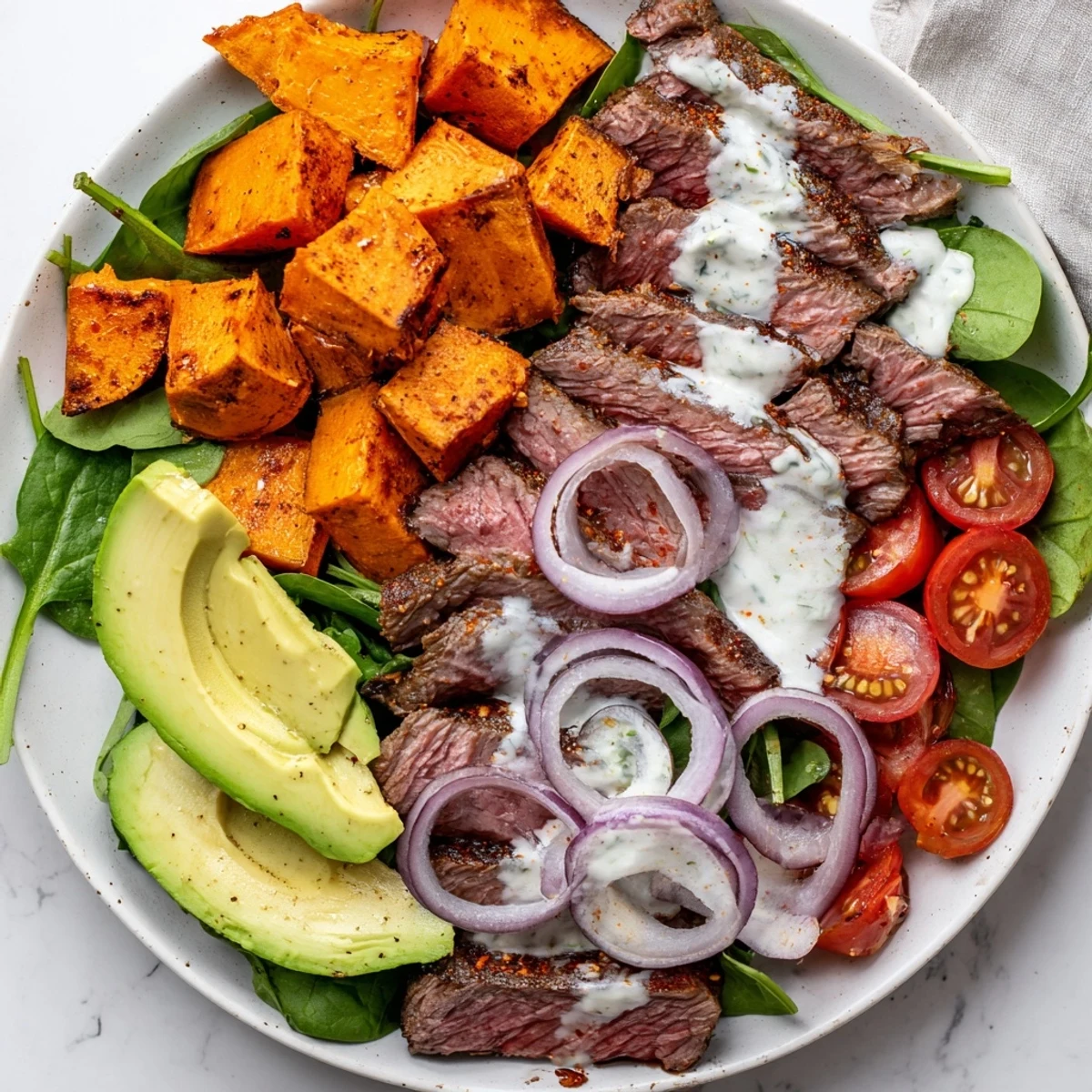 Beef Avocado Sweet Potato Bowl with tender beef, creamy avocado, and roasted sweet potatoes; a colorful dinner.