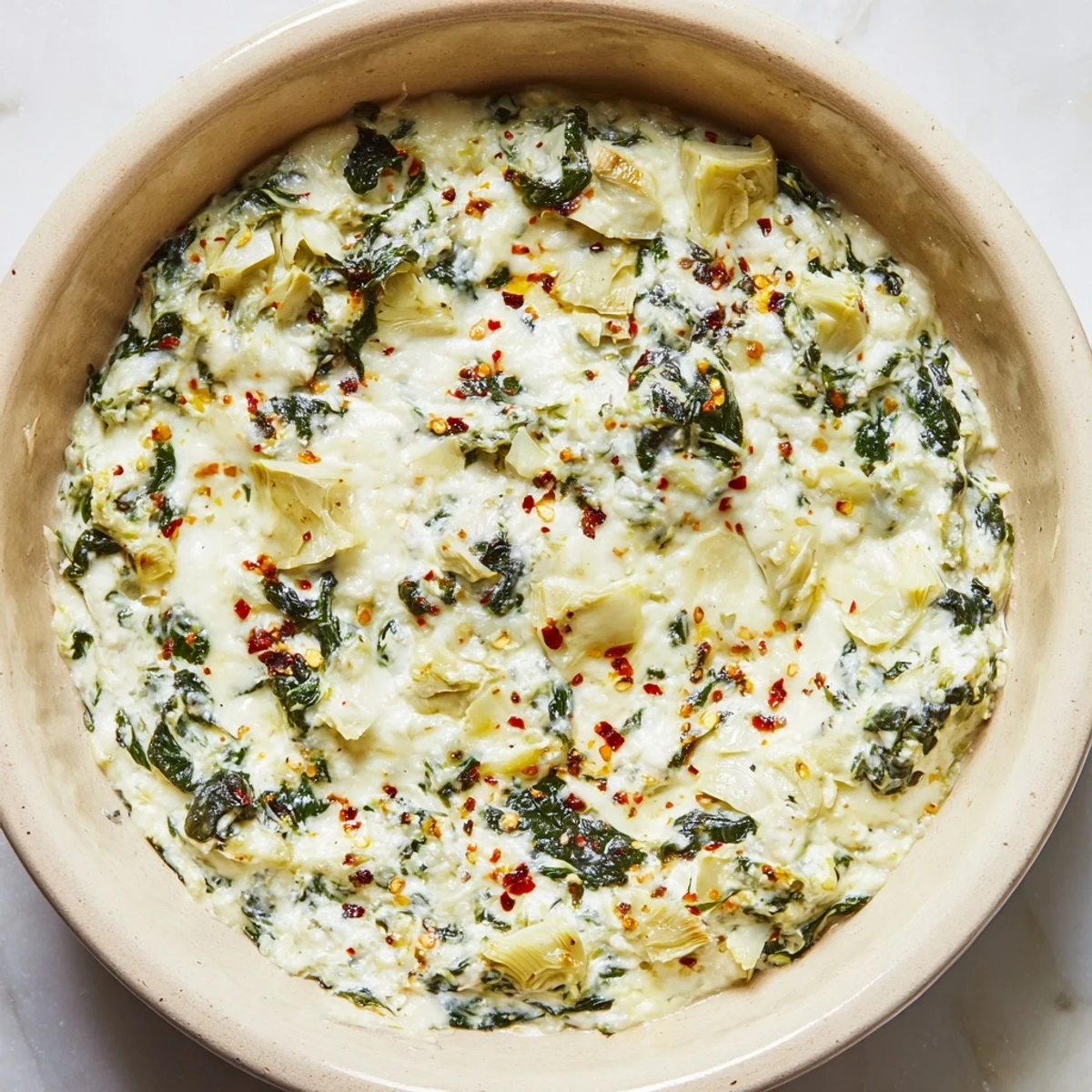 Freshly baked Spinach Artichoke Dip with melted mozzarella, a classic American appetizer.