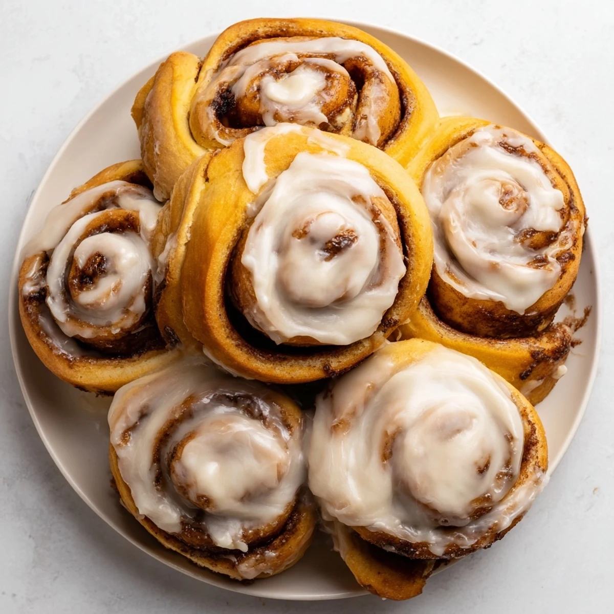Close-up shot shows a tray of freshly baked pumpkin cinnamon rolls, perfect for sharing and enjoying.