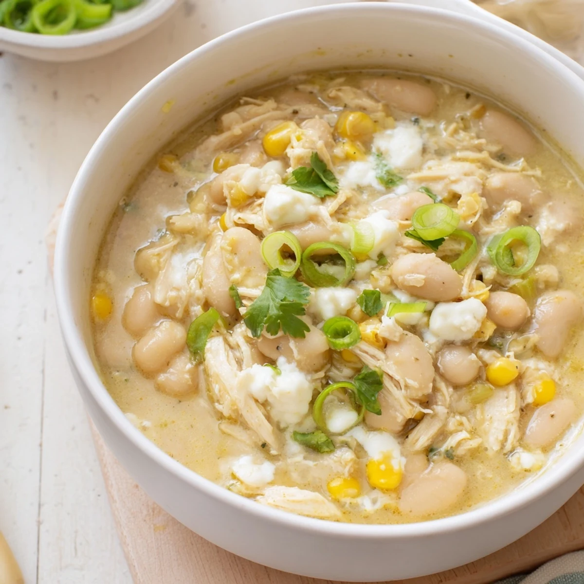 Creamy White Chicken Chili with shredded chicken, white beans, and sweet corn in a hearty broth.  