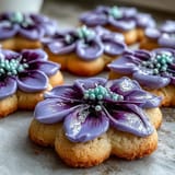 Bright and cheerful flower-shaped cookies decorated with pastel royal icing, perfect for spring celebrations.  