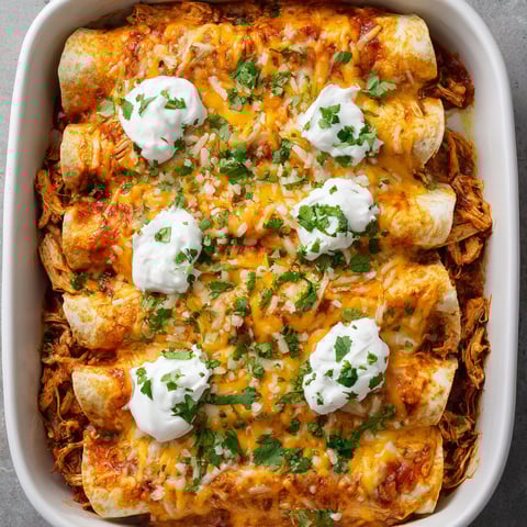 A dish of food with a white sauce on top.