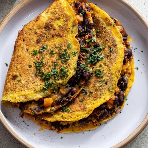 Crispy golden Bean & Cheese Quesadillas, oozing melted cheese, ready to slice with fresh toppings.