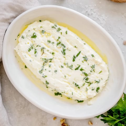 Creamy "Fossil Record" appetizer with herb impressions and cracked nuts, ready to serve and enjoy.