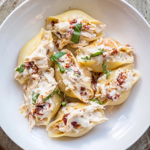 Marry Me Chicken Stuffed Shells, bubbling golden brown, are covered in a rich, creamy tomato sauce.