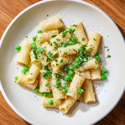 A warm bowl of Garlic Butter Ditalini with Peas, a simple pasta dinner, glistening with butter.