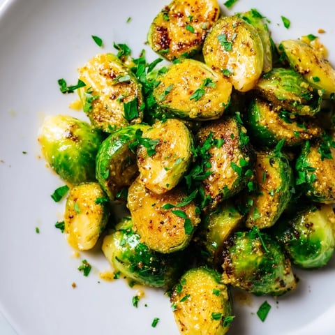Honey mustard glazed Brussels sprouts, glistening with a vibrant glaze, ready to serve as a tasty side.