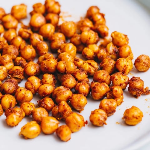 Golden brown Crispy Chickpea Snack roasted with smoky paprika and cumin, served warm in a rustic white bowl.  