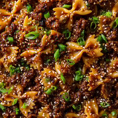 A close up of a dish with noodles and meat.