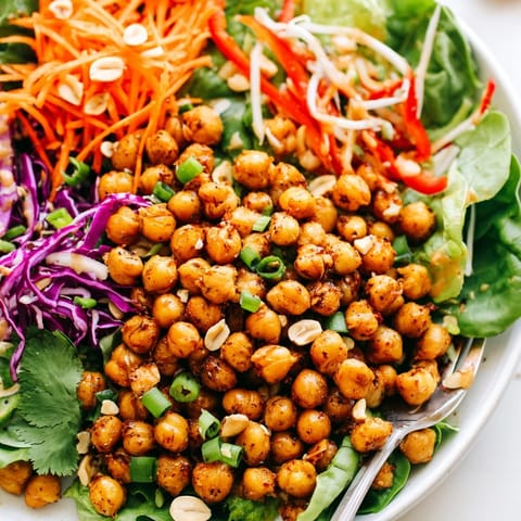 Vibrant Thai Peanut Roasted Chickpea Salad: golden chickpeas tossed with fresh veggies and peanut sauce.