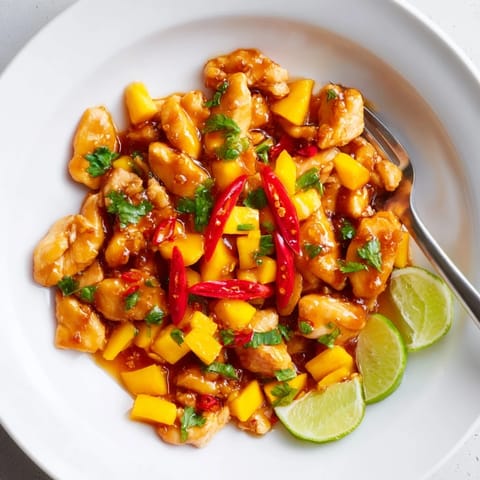 Vibrant Mango Chili Garlic Chicken Skillet garnished with red chili for an extra kick.  