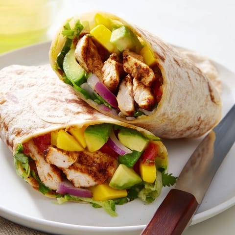 Tasty fusion of grilled chicken and sweet mango in a delightful burrito.  