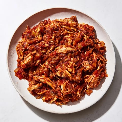 Tender, juicy Crock-Pot Shredded Chicken Tacos with vibrant toppings like cilantro and fresh lime slices.