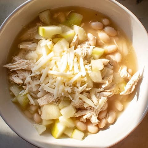 This creamy 35-Minute White Cheddar Apple Chicken Chili features tender chicken and sweet apples simmered with white beans.