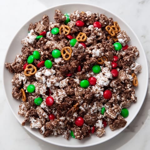 Close-up of a festive bowl overflowing with sweet and crunchy Simplified Reindeer Chow snack mix.