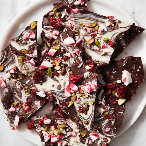 A beautiful display of homemade holiday bark, studded with pistachios and cranberries, ready to enjoy.