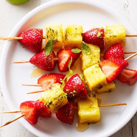 Fresh, colorful Fruit Skewers featuring juicy pineapple and sweet strawberries, ready to enjoy.