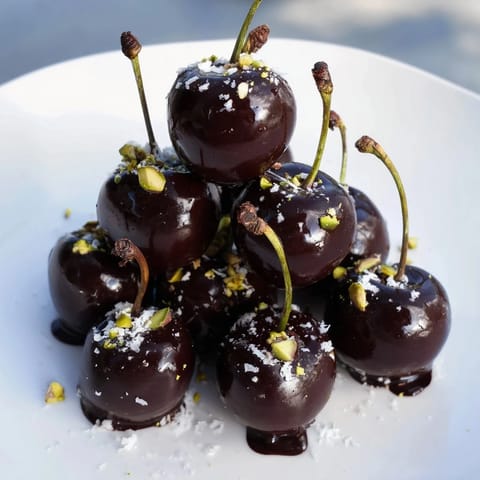 A stunning pyramid of chocolate-covered cherry dessert bites, ready to be enjoyed as the perfect sweet snack.