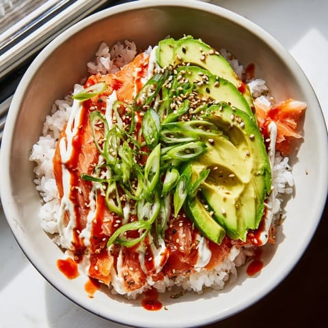 This satisfying bowl of Classic Salmon Rice shows tender salmon, fluffy rice, and fresh avocado slices too.