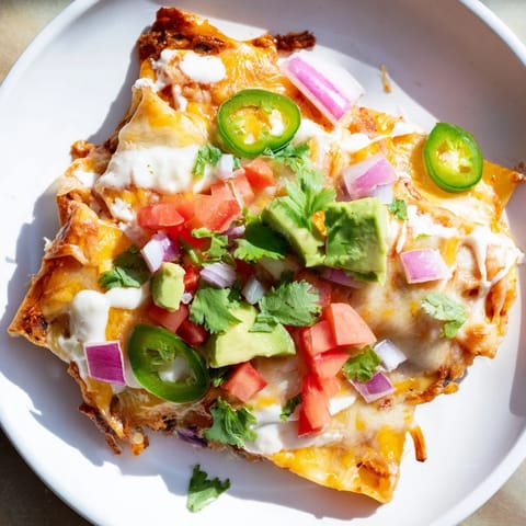 Cheesy, crispy pasta chips nachos: A flavorful appetizer loaded with fresh diced tomatoes and cilantro.