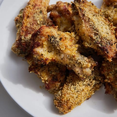 Close-up of freshly baked Parmesan Chicken Wings; crispy and perfectly coated for a fantastic appetizer.