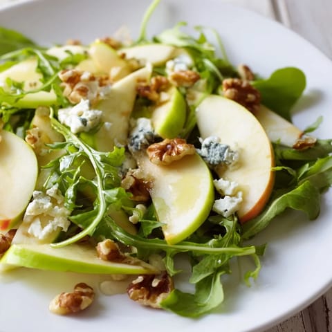 A close-up of crisp Apple and Walnut Salad with crumbled cheese, celery, and vinaigrette, ready to serve as an appetizer.  