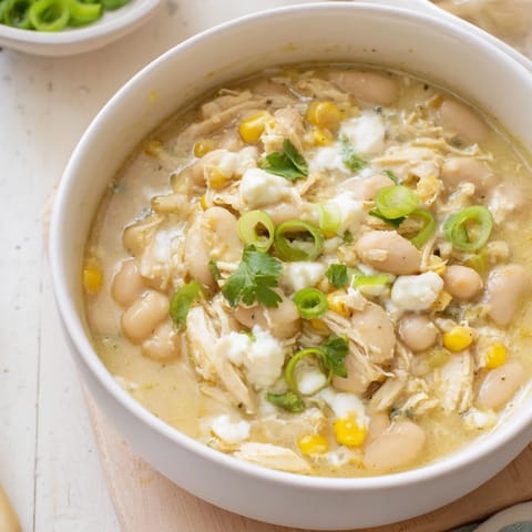 Creamy White Chicken Chili with shredded chicken, white beans, and sweet corn in a hearty broth.  