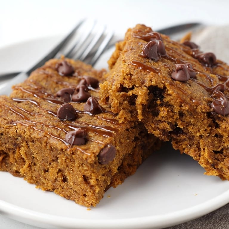 Golden-brown Gingerbread Pumpkin Chocolate Chip Bars&amp;mdash;a spiced, sweet baked treat, perfect warm.