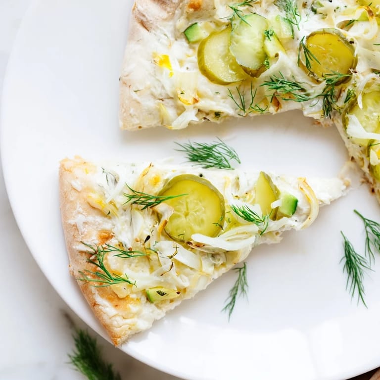 Savor this unique Pickle Pizza, featuring rich crème fraîche and fresh dill for flavor.