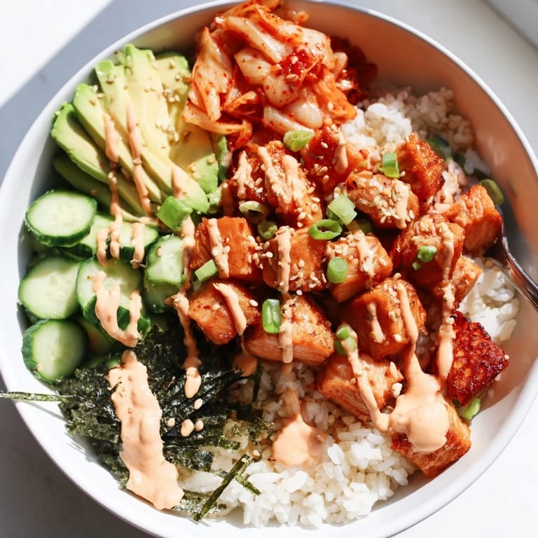 A delicious crispy salmon rice bowl featuring kimchi, avocado, and garlic crunch.  