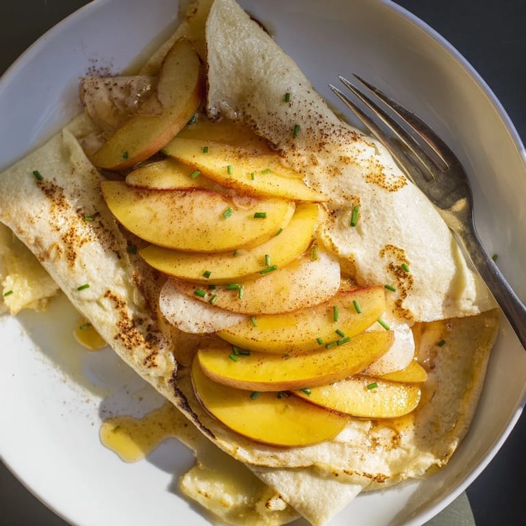 Mouthwatering apple and Brie tacos served on golden tortillas with fresh chives.