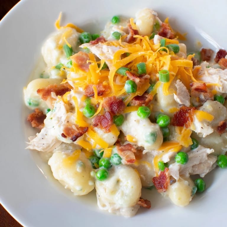 Imagine tender gnocchi coated in a creamy sauce, with visible bacon and cheddar, highlighting this delicious Creamy Crack Chicken Gnocchi recipe.