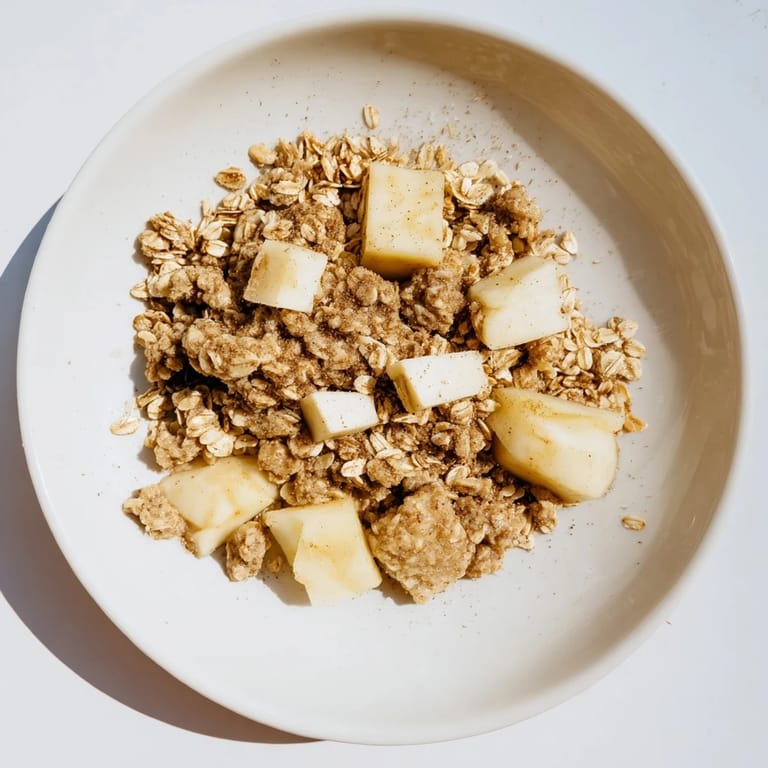 Warm, comforting image of Best Apple Crisp with a crispy oat-almond topping, ready to serve.